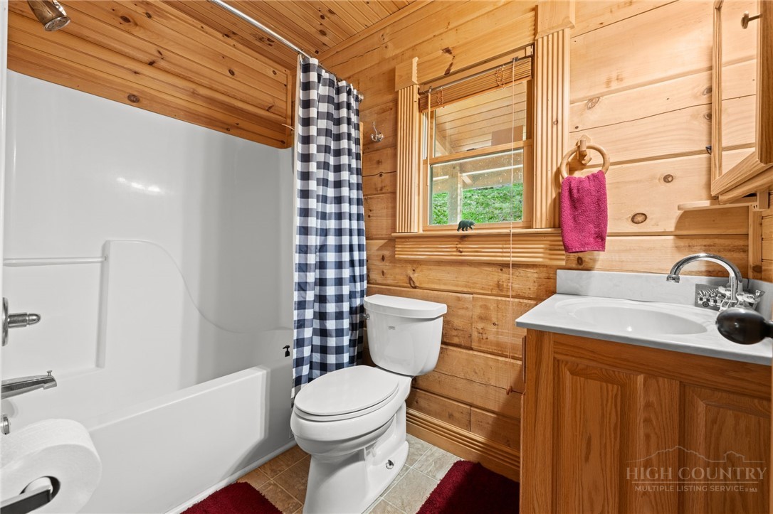 613 Silas Creek Road Lansing, NC 28643 - Photo 31 of 40 a bathroom with a sink toilet and shower