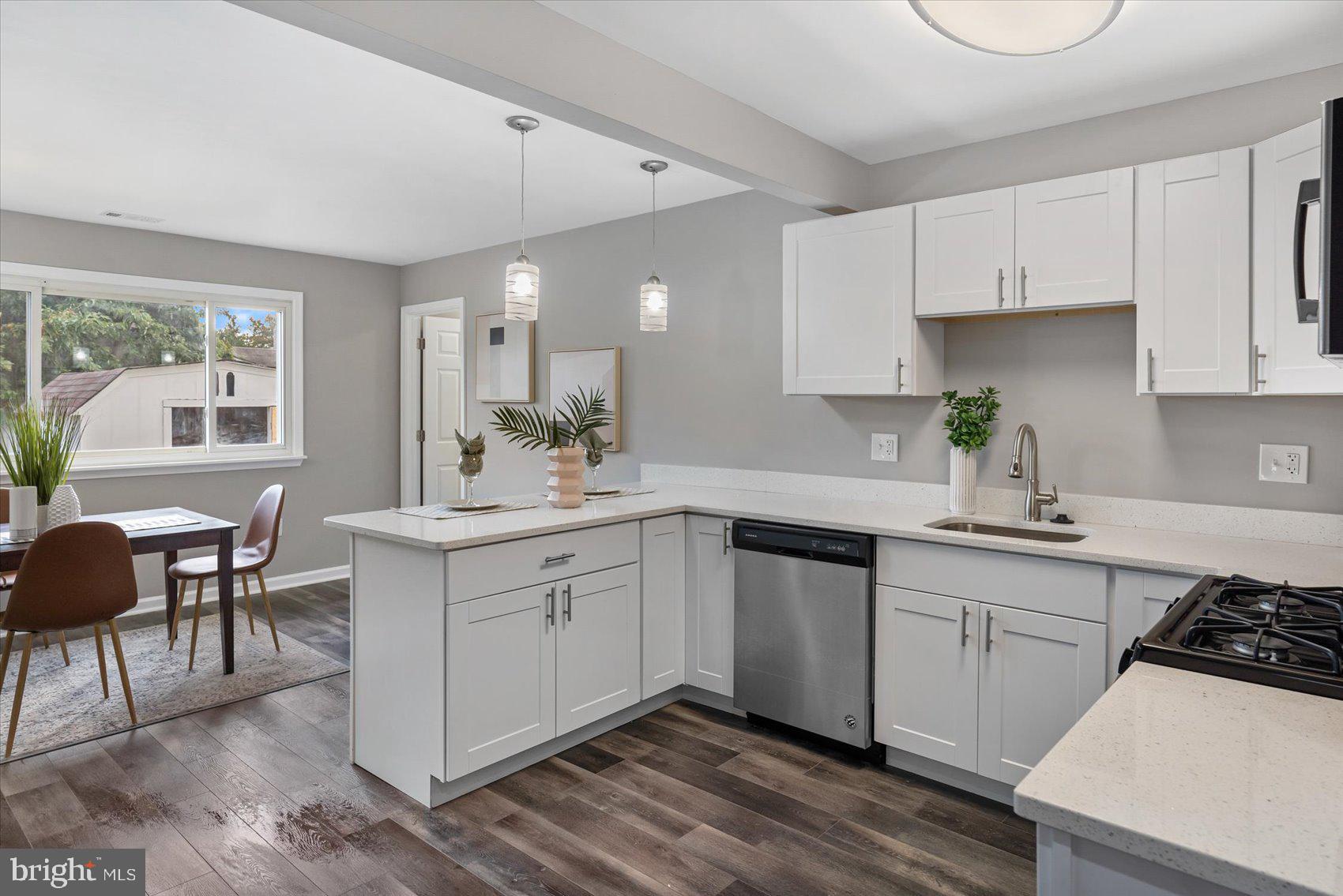 8217 Bullneck Road Baltimore, MD 21222 - Photo 13 of 41 a kitchen with a sink cabinets and wooden floor