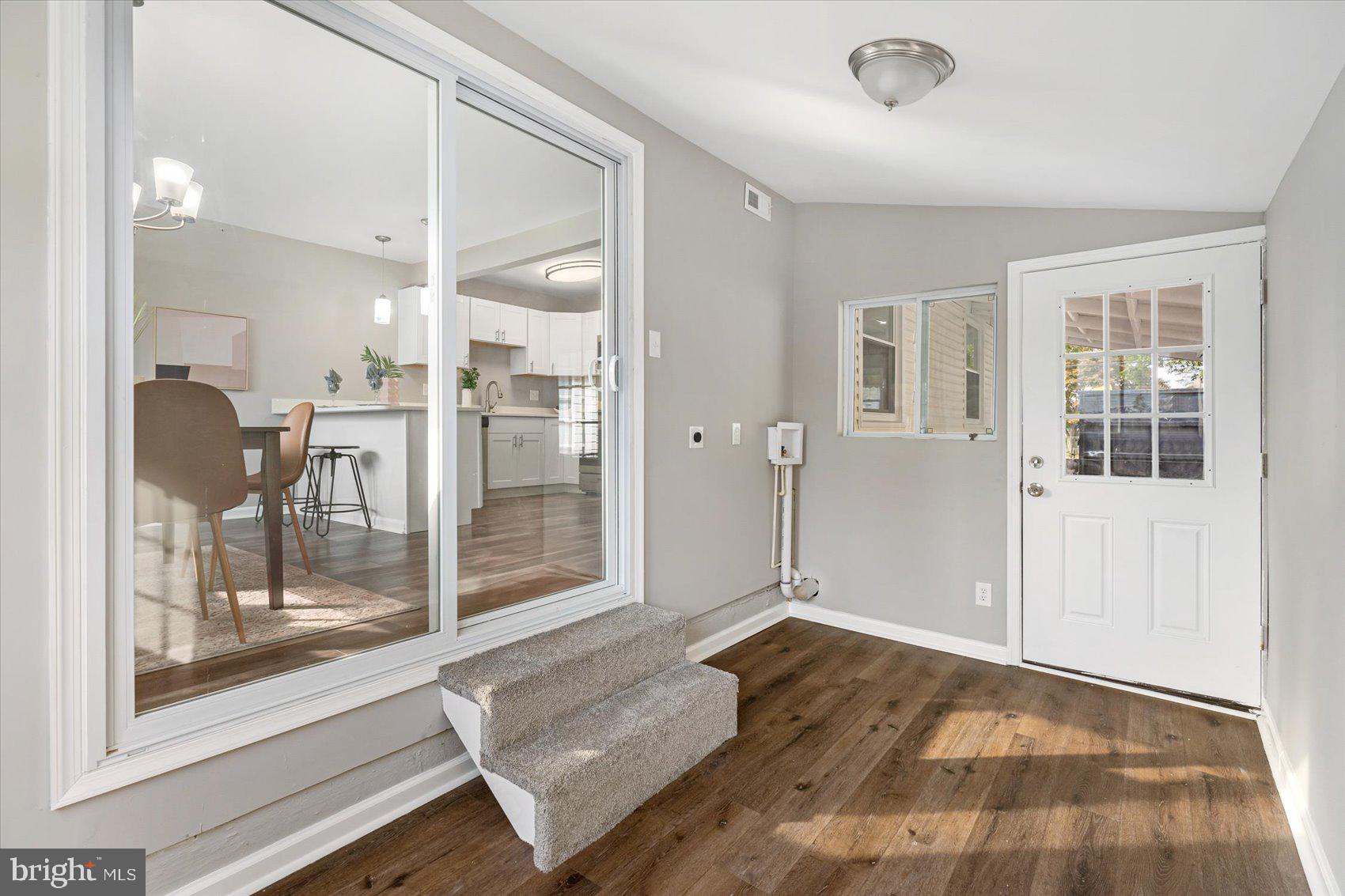 8217 Bullneck Road Baltimore, MD 21222 - Photo 19 of 41 a view of livingroom with furniture and floor to ceiling window