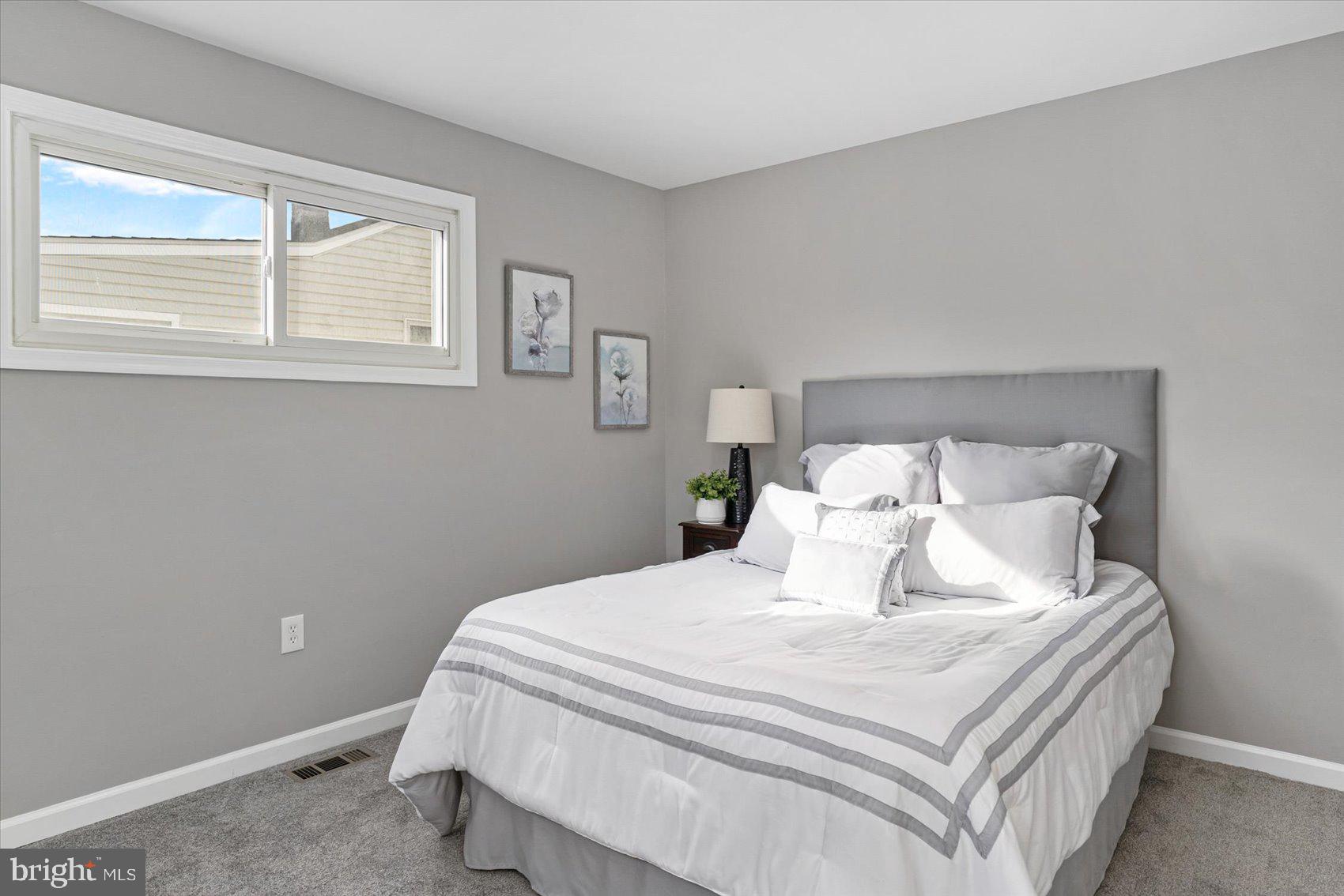 8217 Bullneck Road Baltimore, MD 21222 - Photo 23 of 41 a bedroom with a bed and a window