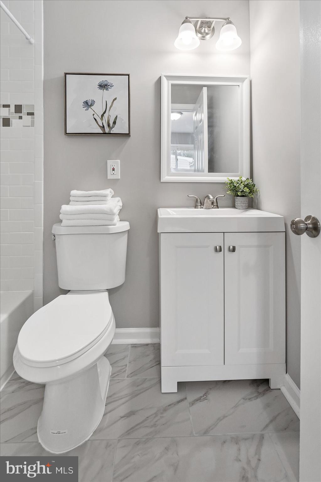 8217 Bullneck Road Baltimore, MD 21222 - Photo 24 of 41 a bathroom with a toilet sink and mirror