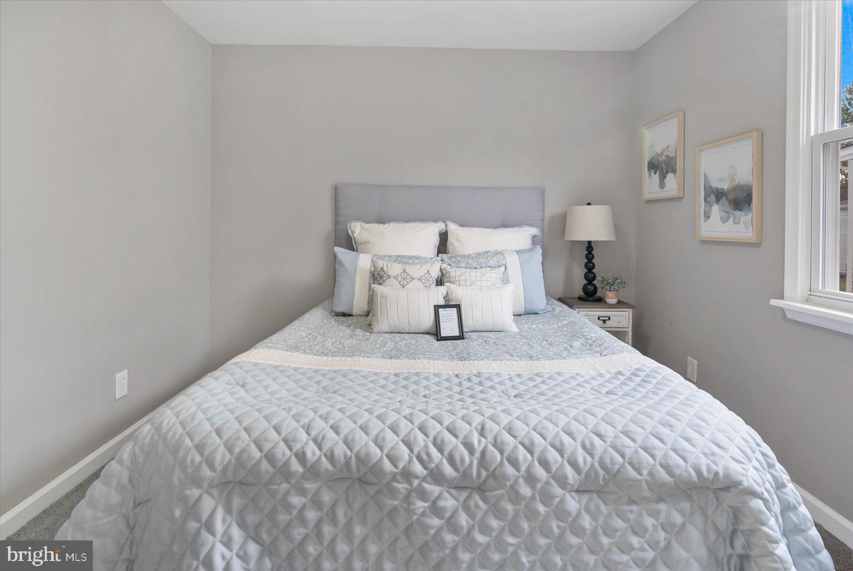 8217 Bullneck Road Baltimore, MD 21222 - Photo 26 of 41 a large bed sitting in a bedroom next to a window