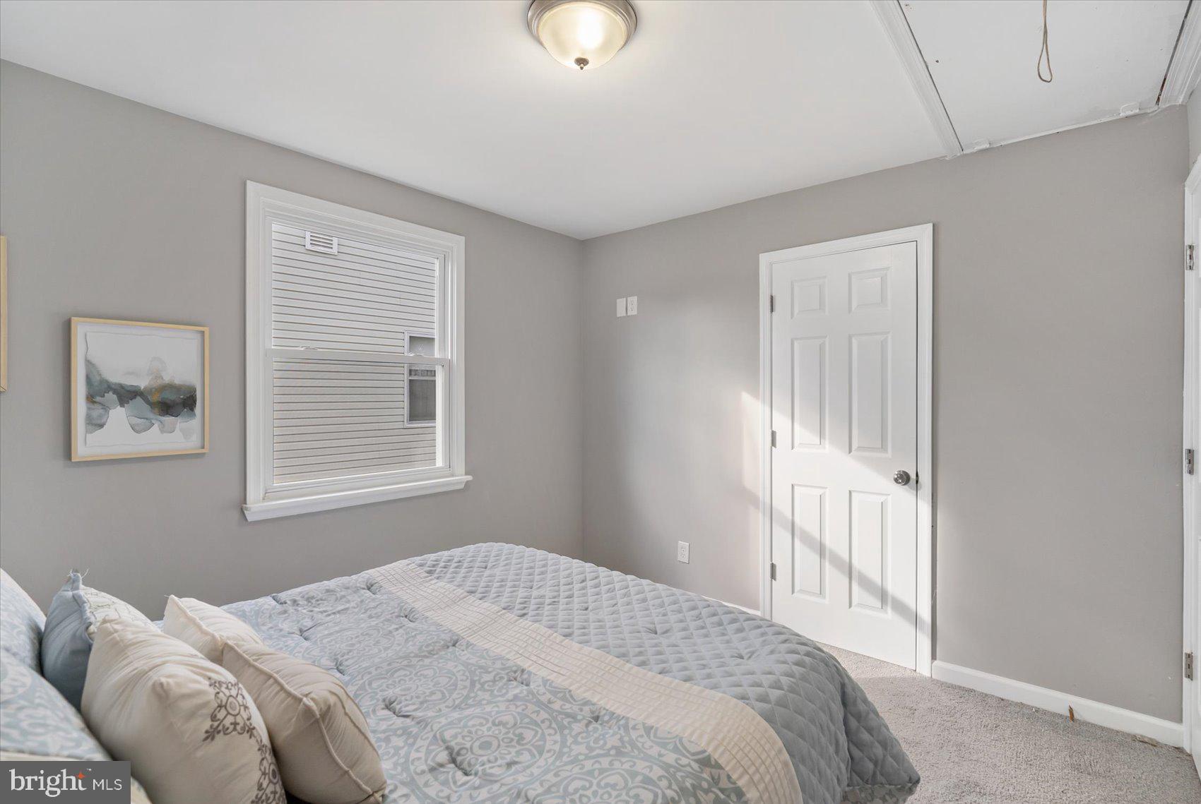 8217 Bullneck Road Baltimore, MD 21222 - Photo 28 of 41 a bedroom with a bed and a window
