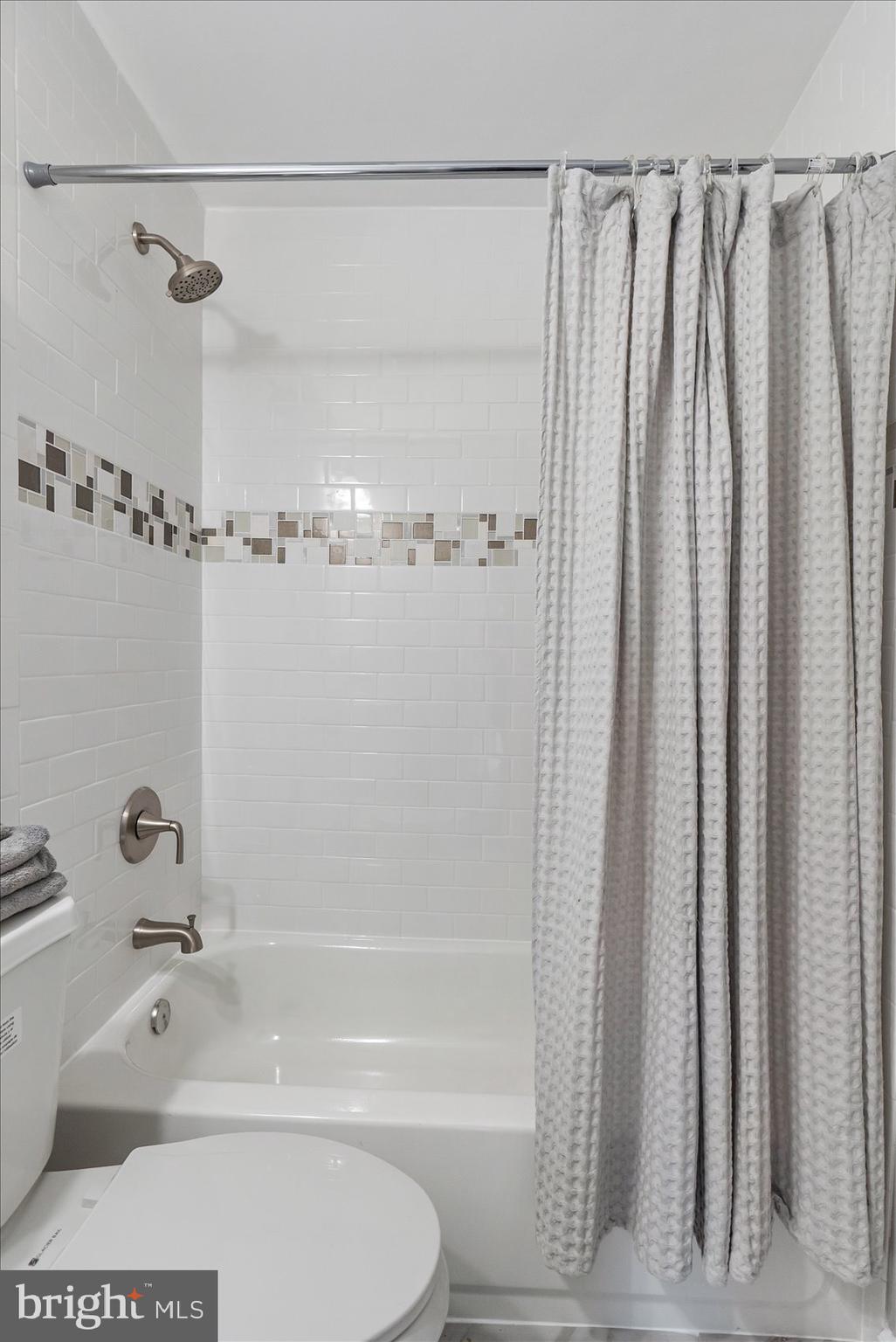 8217 Bullneck Road Baltimore, MD 21222 - Photo 30 of 41 a bathroom with a shower and a tub