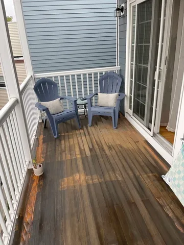 a view of roof deck with couches and city view