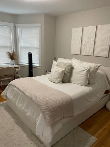 a bedroom with a bed and a large mirror