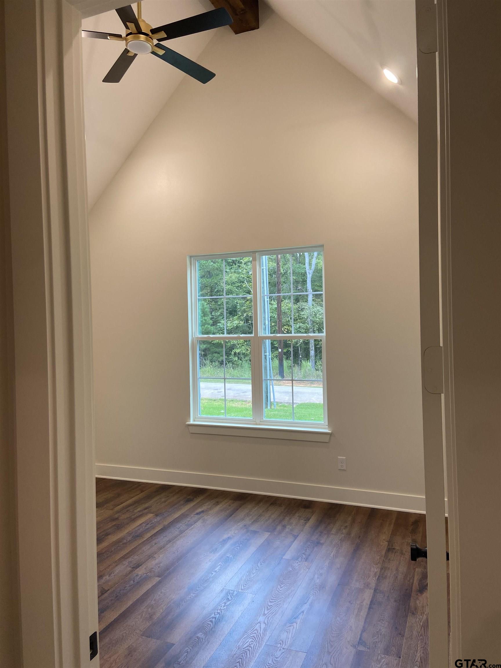 18690 Windjammer Place Flint, TX 75762 - Photo 11 of 47 an empty room with wooden floor closet and windows