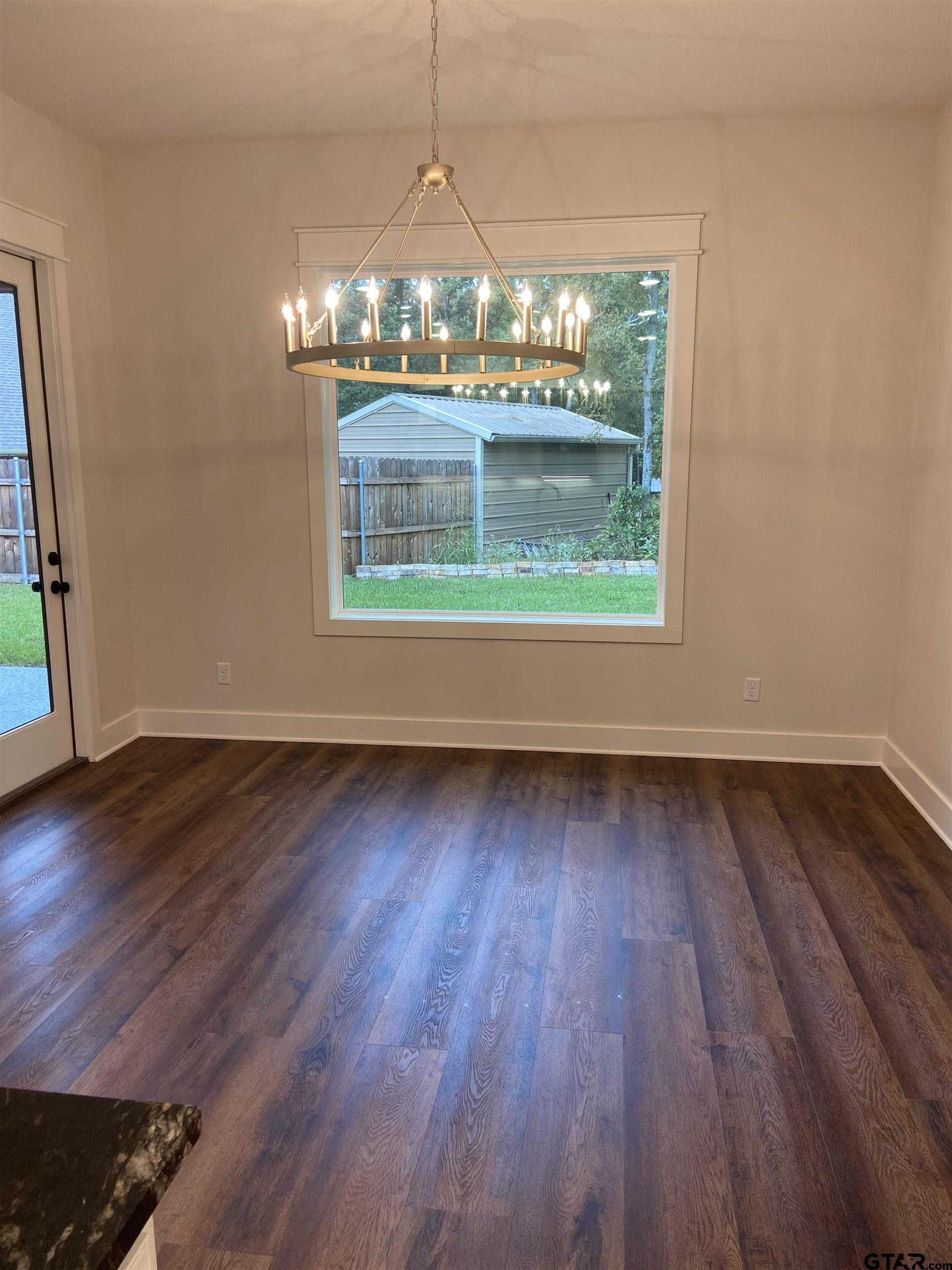 18690 Windjammer Place Flint, TX 75762 - Photo 12 of 47 a view of a room with wooden floor and window