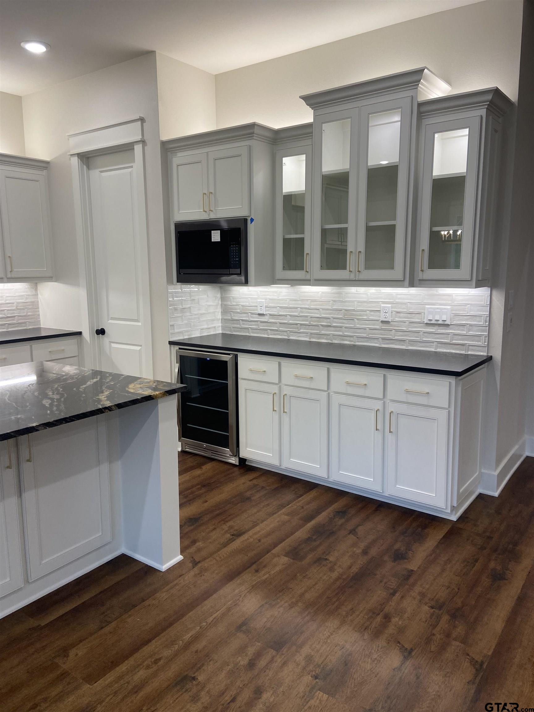 18690 Windjammer Place Flint, TX 75762 - Photo 15 of 47 a large kitchen with granite countertop a stove and a sink