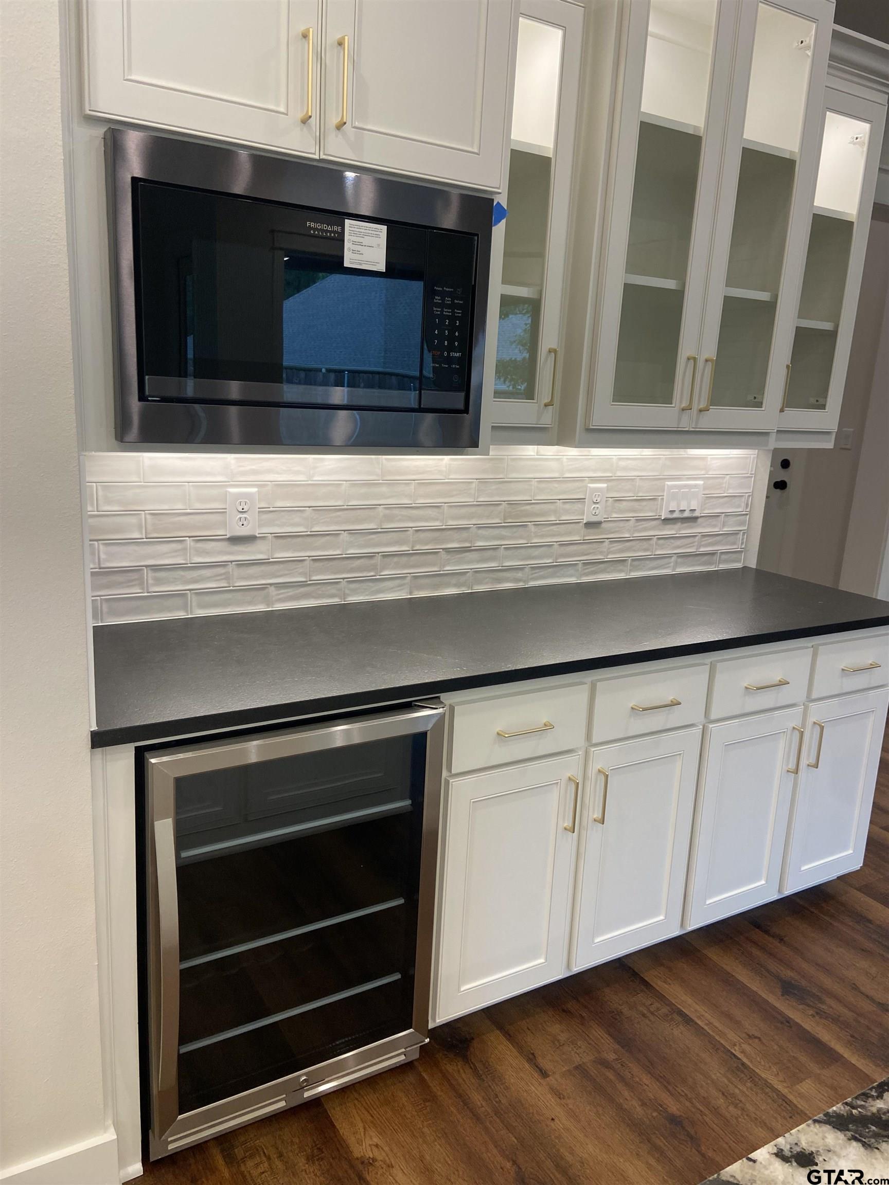 18690 Windjammer Place Flint, TX 75762 - Photo 17 of 47 a kitchen with granite countertop white cabinets and white appliances
