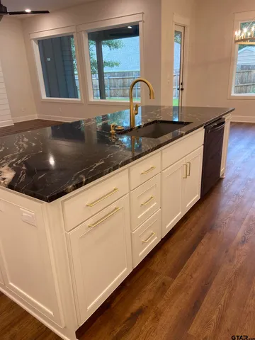 a kitchen with granite countertop white cabinets and a granite counter tops