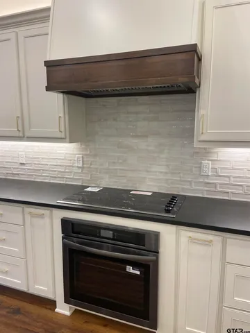 a close view of a stove a microwave and a sink