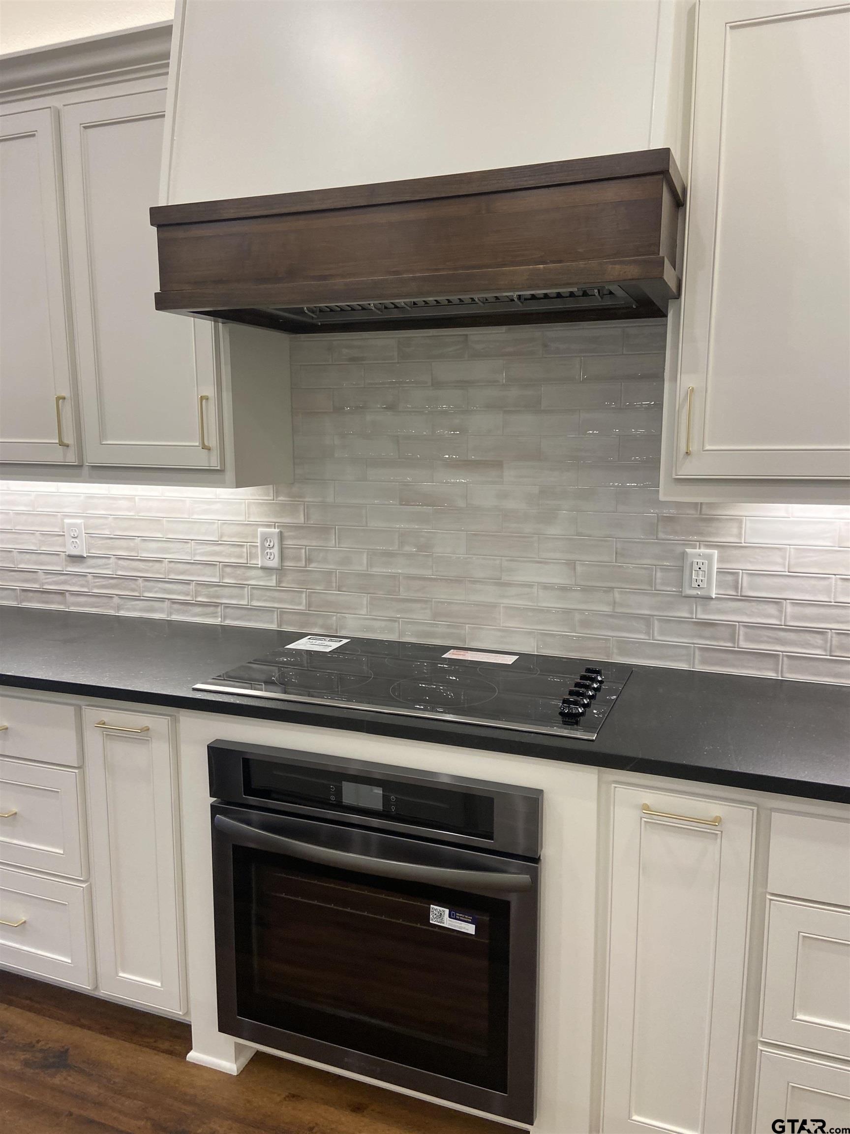 18690 Windjammer Place Flint, TX 75762 - Photo 20 of 47 a close view of a stove a microwave and a sink