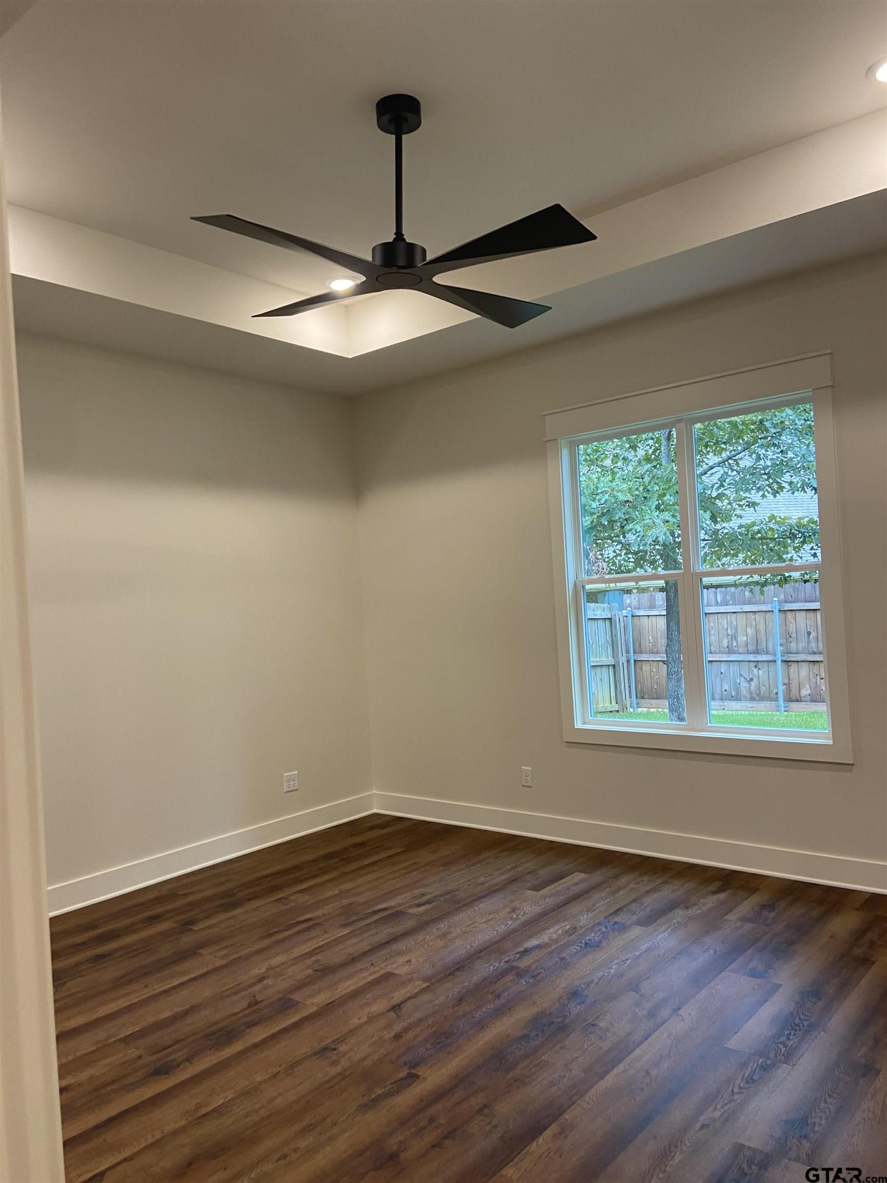 18690 Windjammer Place Flint, TX 75762 - Photo 30 of 47 a view of an empty room with wooden floor and a window