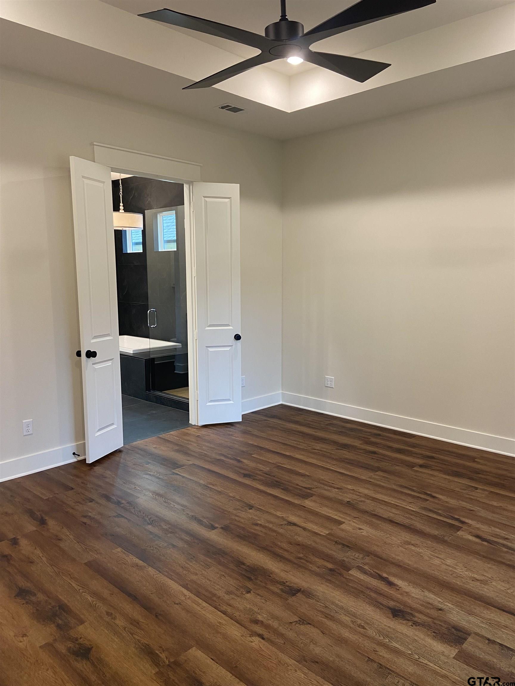 18690 Windjammer Place Flint, TX 75762 - Photo 31 of 47 an empty room with wooden floor and windows