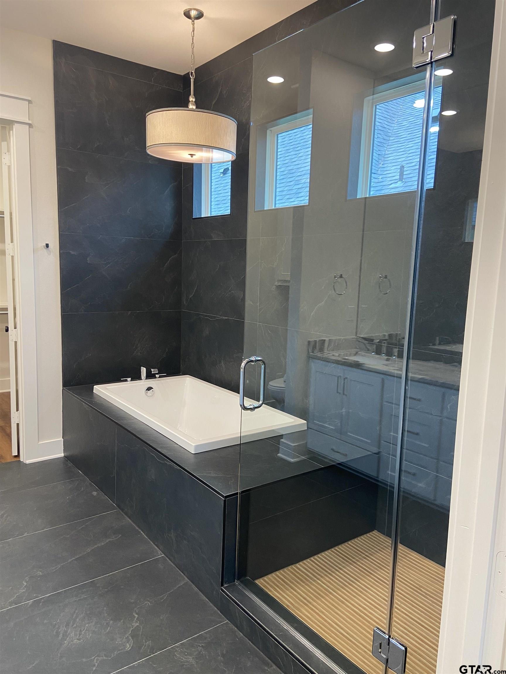 18690 Windjammer Place Flint, TX 75762 - Photo 32 of 47 a bathroom with a sink and a mirror