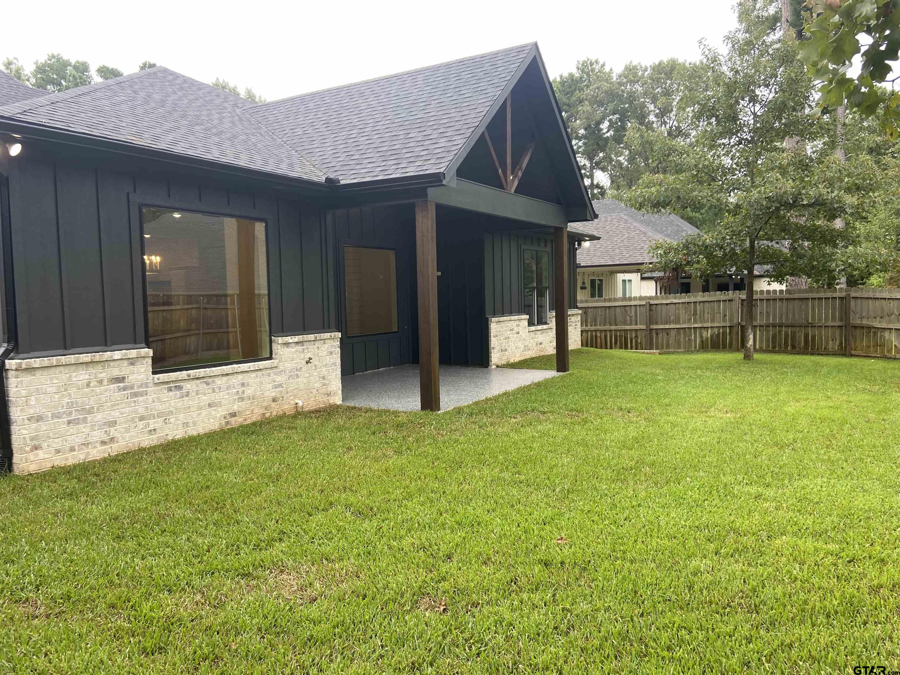 18690 Windjammer Place Flint, TX 75762 - Photo 46 of 47 a view of a house with a yard and a large tree