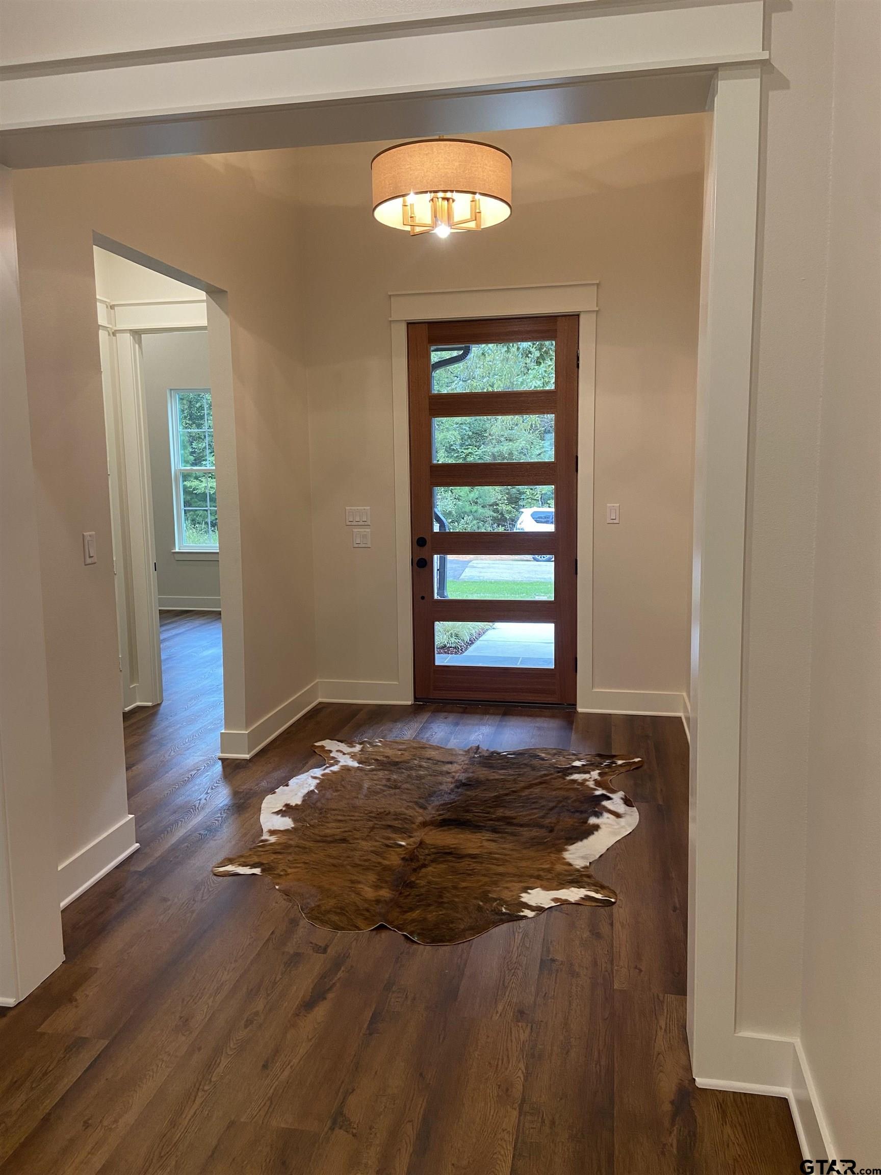 18690 Windjammer Place Flint, TX 75762 - Photo 7 of 47 a view of an empty room with window and wooden floor