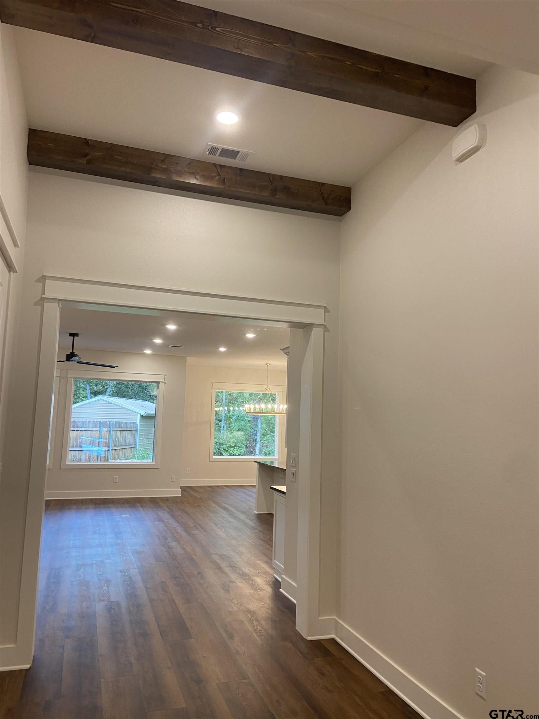 18690 Windjammer Place Flint, TX 75762 - Photo 8 of 47 a view of an empty room with a window and wooden floor
