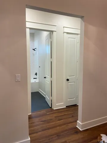 a view of a bathroom with wooden floor