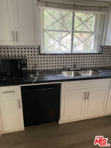 a kitchen with a sink and a microwave