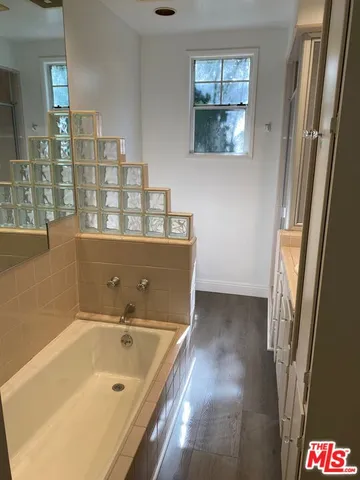 a bathroom with a bathtub and shower
