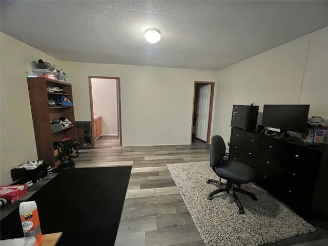 a living room with furniture rug and a flat screen tv