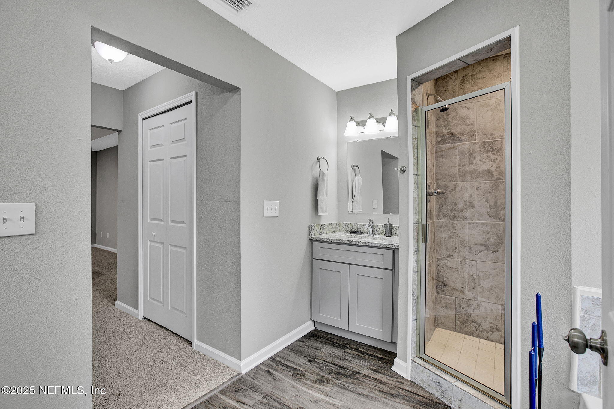 7442 Richardson Road Jacksonville, FL 32209 - Photo 11 of 15 a bathroom with a granite countertop shower mirror and a sink