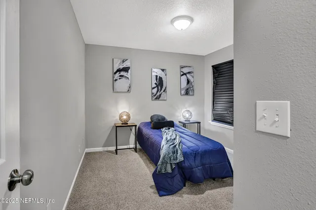 a living room with furniture and wall paintings