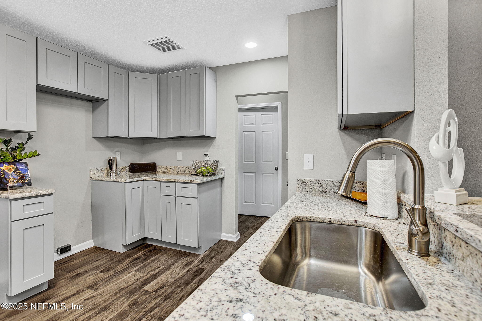 7442 Richardson Road Jacksonville, FL 32209 - Photo 6 of 15 a kitchen with a sink cabinets and stainless steel appliances