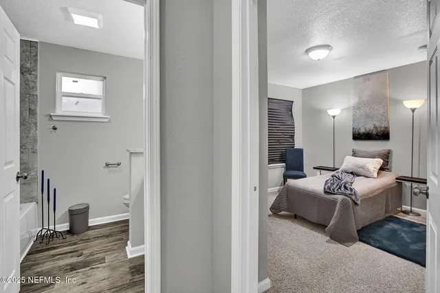 a bedroom with furniture and a mirror