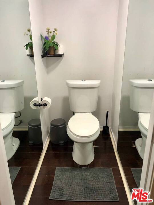 9601 Heather Road Beverly Hills, CA 90210 - Photo 16 of 17 a white toilet sitting next to a shower