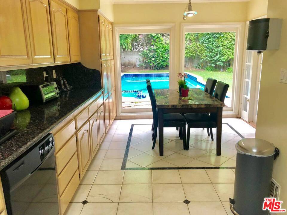 9601 Heather Road Beverly Hills, CA 90210 - Photo 5 of 17 a view of a dining room with furniture window and outside view