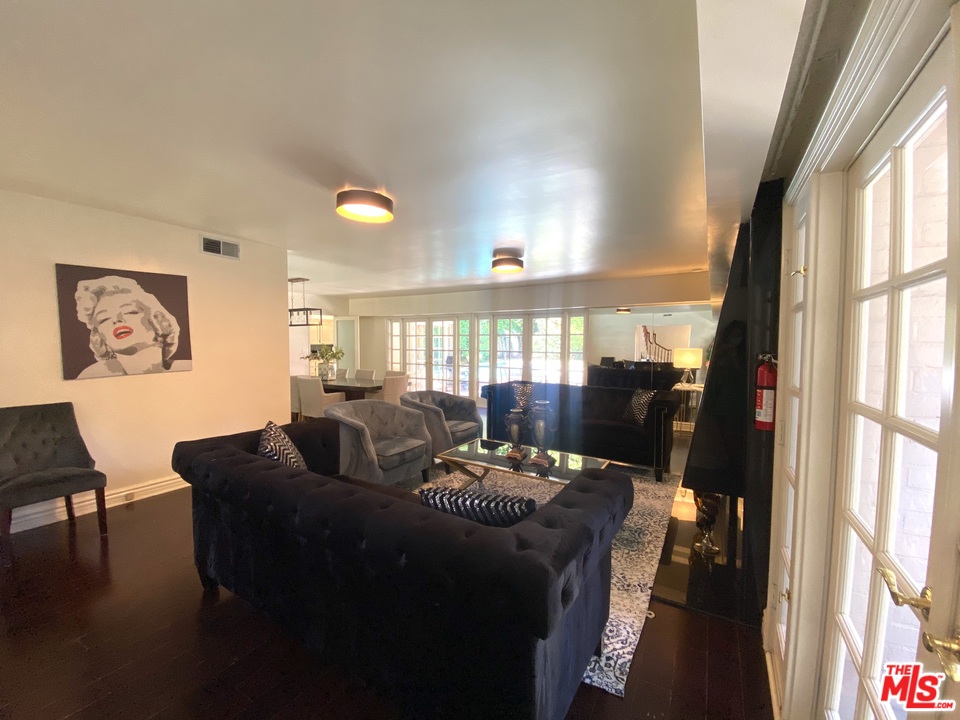 9601 Heather Road Beverly Hills, CA 90210 - Photo 8 of 17 a living room with furniture and a large window