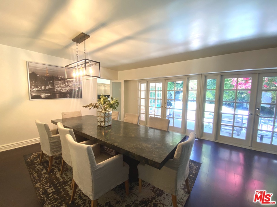9601 Heather Road Beverly Hills, CA 90210 - Photo 9 of 17 a view of a dining room with furniture and wooden floor
