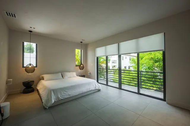 a bedroom with a large bed and a large window