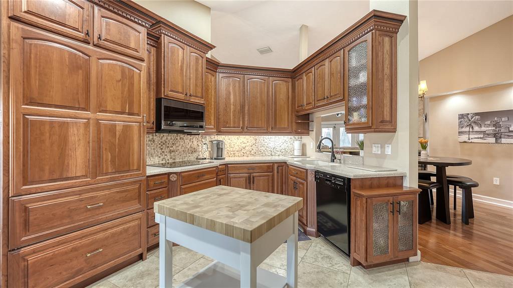 5968 Rachele Drive Sarasota, FL 34243 - Photo 20 of 55 a kitchen with granite countertop stainless steel appliances and wooden cabinets