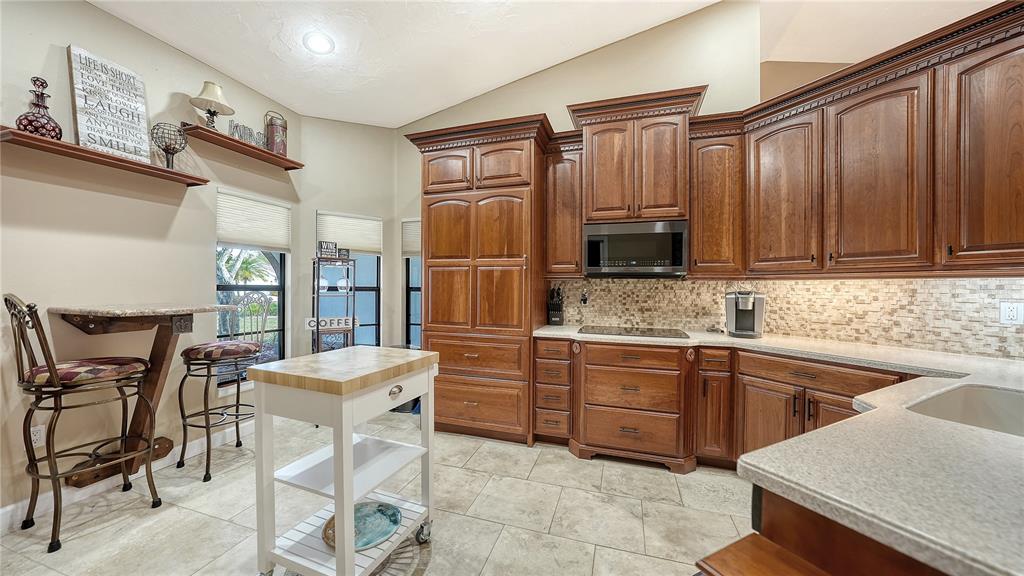 5968 Rachele Drive Sarasota, FL 34243 - Photo 21 of 55 a kitchen with stainless steel appliances granite countertop a stove top oven a sink dishwasher and a refrigerator