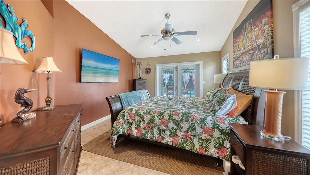 5968 Rachele Drive Sarasota, FL 34243 - Photo 24 of 55 a bedroom with bed and a chandelier