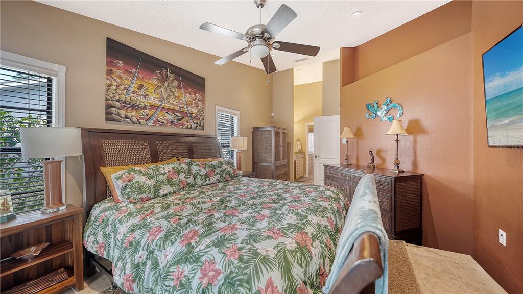 5968 Rachele Drive Sarasota, FL 34243 - Photo 26 of 55 a bedroom with a bed a dresser and chair