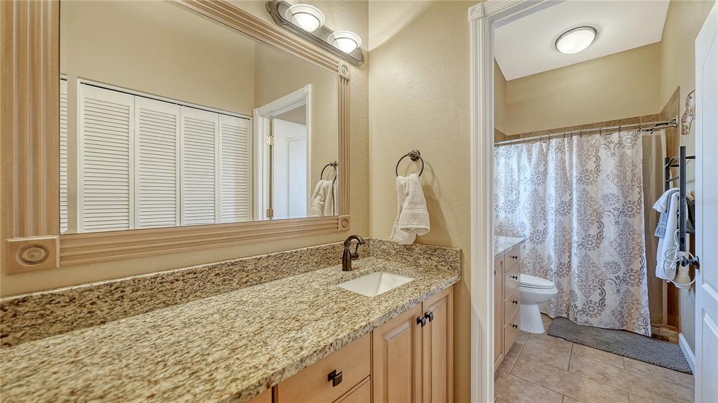 5968 Rachele Drive Sarasota, FL 34243 - Photo 28 of 55 a bathroom with a granite countertop sink and a mirror