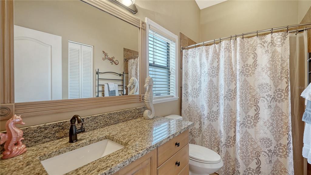 5968 Rachele Drive Sarasota, FL 34243 - Photo 29 of 55 a bathroom with a granite countertop sink and a mirror