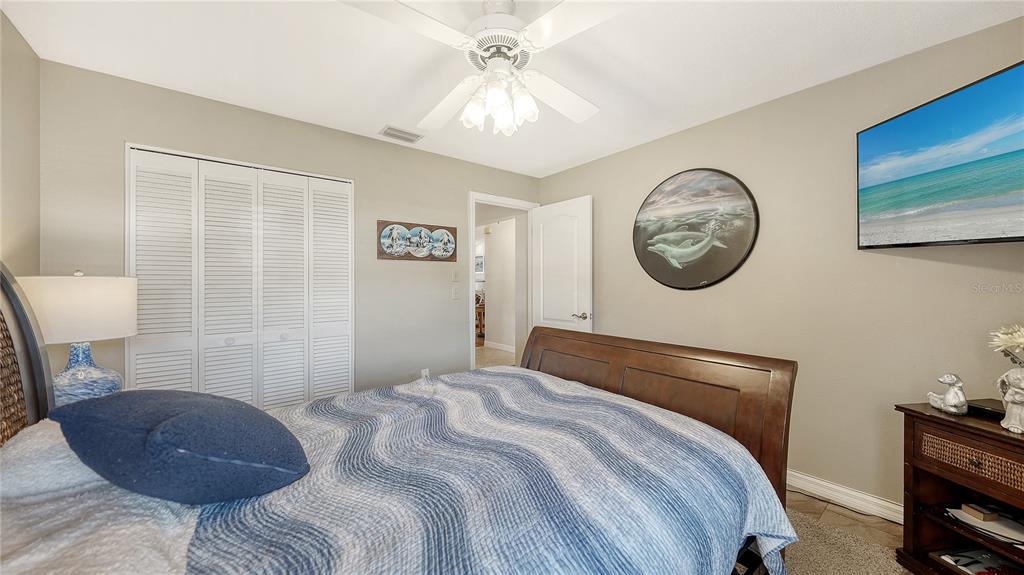 5968 Rachele Drive Sarasota, FL 34243 - Photo 32 of 55 a bedroom with a bed and a chandelier