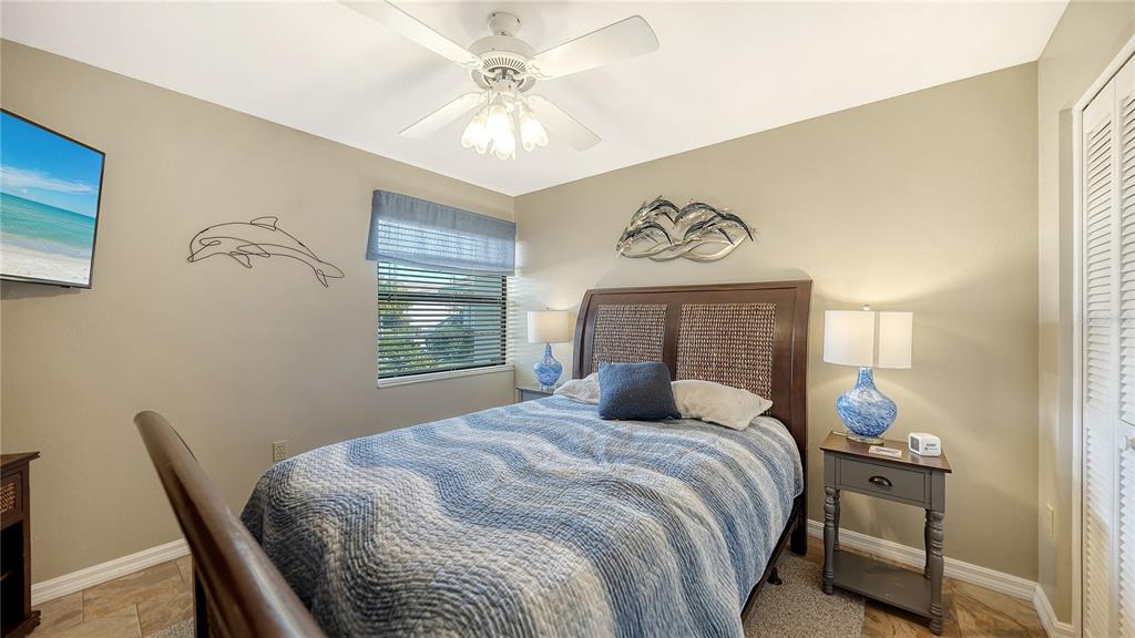 5968 Rachele Drive Sarasota, FL 34243 - Photo 33 of 55 a bedroom with a bed and a table in it