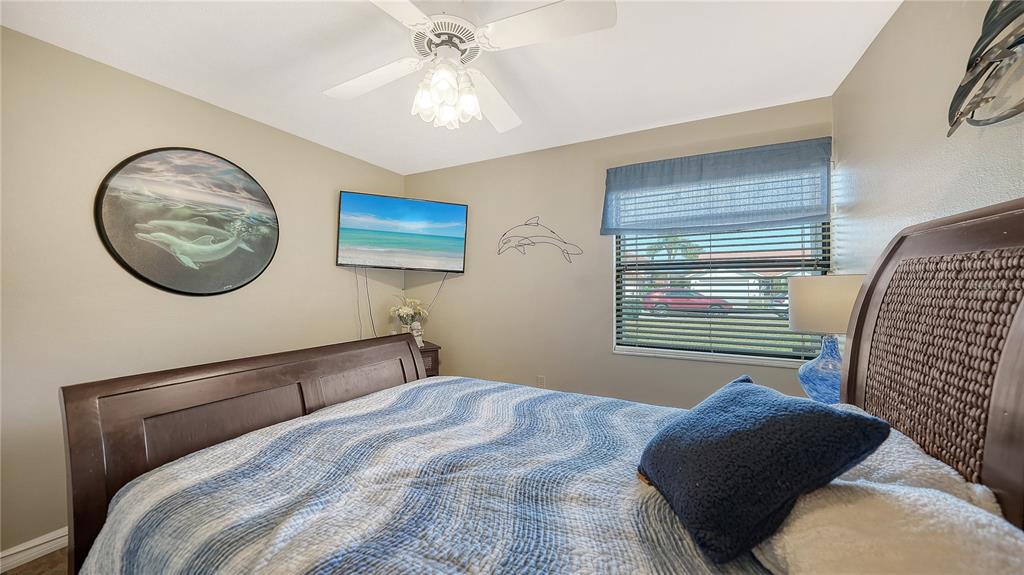 5968 Rachele Drive Sarasota, FL 34243 - Photo 34 of 55 a bedroom with a bed and a painting on the wall