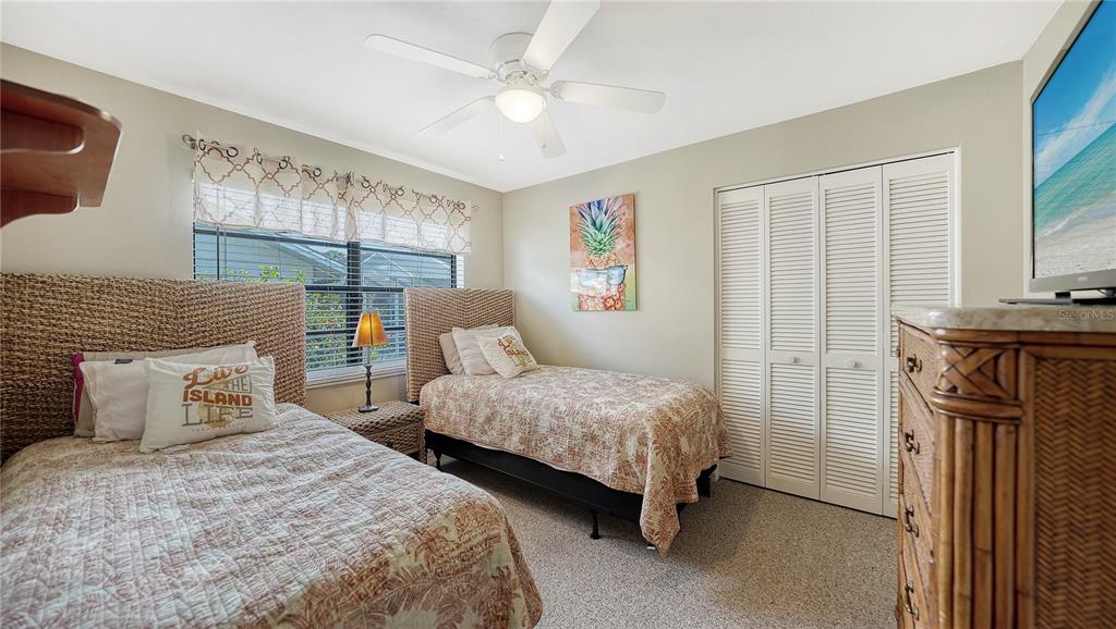 5968 Rachele Drive Sarasota, FL 34243 - Photo 37 of 55 a bedroom with two beds and a chandelier