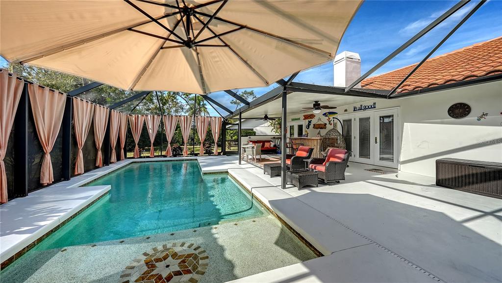 5968 Rachele Drive Sarasota, FL 34243 - Photo 42 of 55 a view of a backyard with a patio and a umbrella