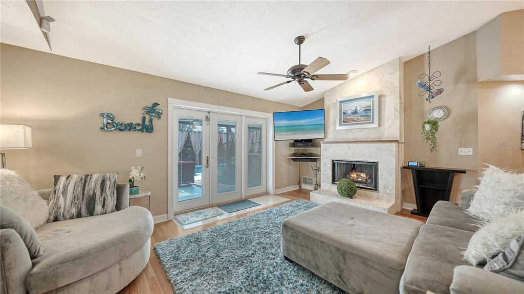 5968 Rachele Drive Sarasota, FL 34243 - Photo 6 of 55 a living room with furniture and a fireplace