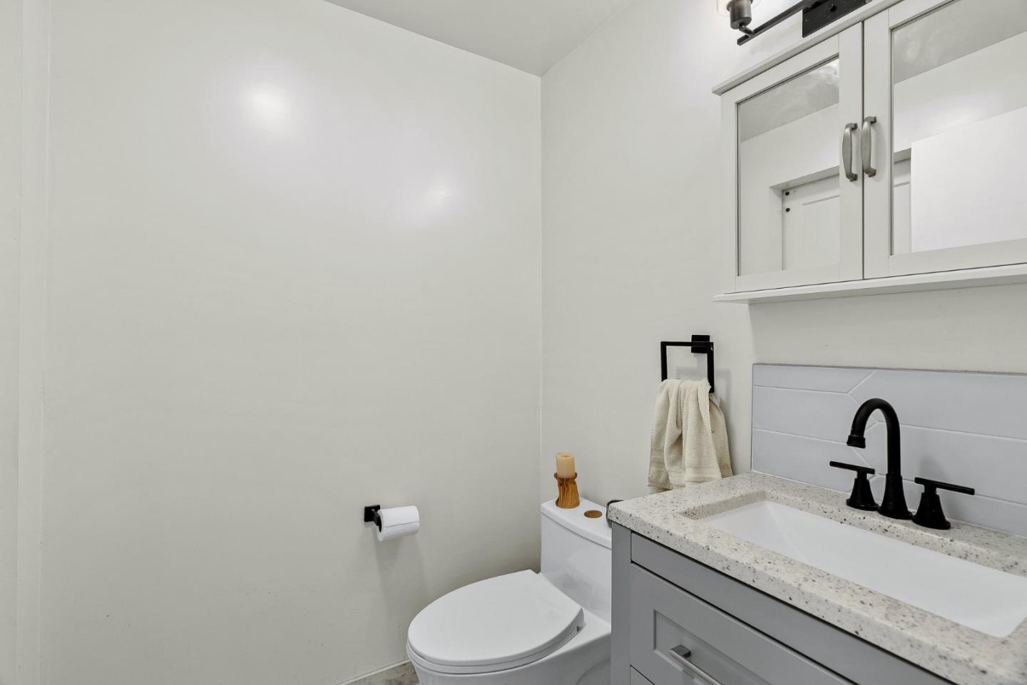 4900 Trout Gulch Road Aptos, CA 95003 - Photo 9 of 33 a bathroom with a sink a toilet and mirror