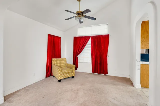 an empty room with a window and a dresser